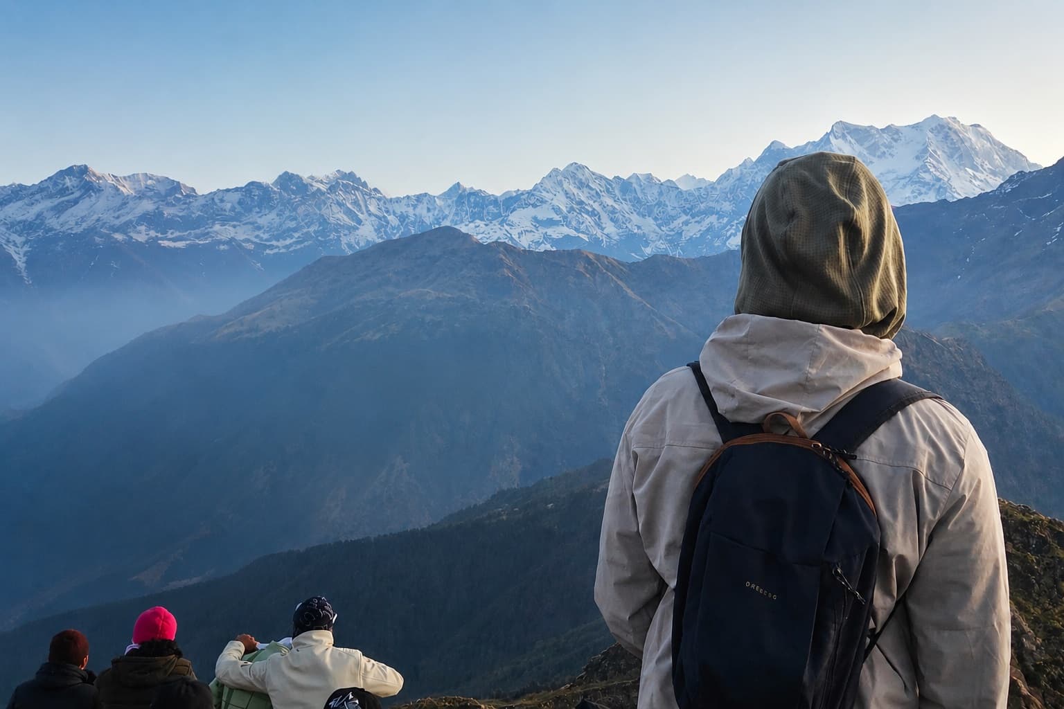 A lone traveler overlooking a misty mountain valley